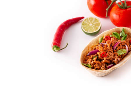 Mexican barquita taco with beef, chilli, tomato, onion and spices isolated on white backgroundの写真素材