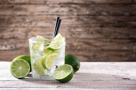 Caipiroska cocktail with lime on wooden tableの写真素材