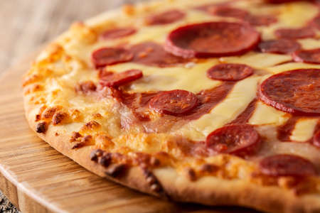 Italian pepperoni pizza on wooden tableの写真素材