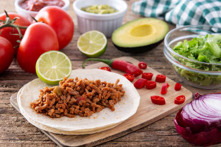 Mexican tacos ingredients on wooden tableの写真素材