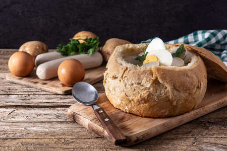 Zurek. Traditional Polish soup on wooden tableの写真素材