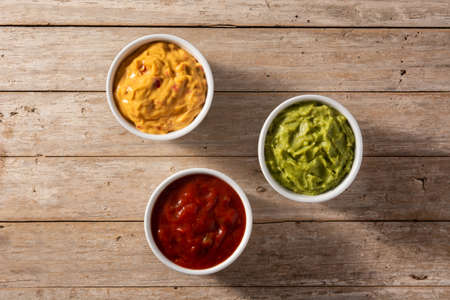 Traditional Mexican sauces. Guacamole, chilli pepper sauce and cheese sauceの写真素材