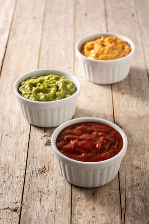 Traditional Mexican sauces. Guacamole, chilli pepper sauce and cheese sauce
