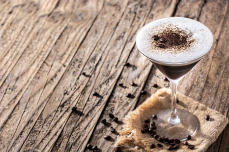 Martini espresso cocktail in glass on wooden tableの写真素材