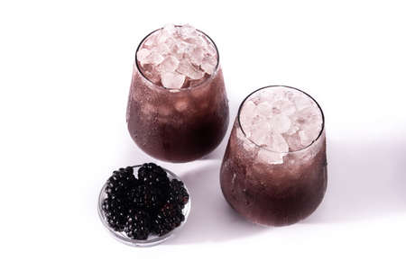 Fresh blackberry cocktail in cold glass isolated on white backgroundの写真素材