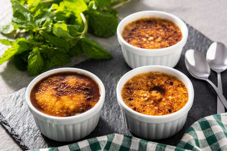 Homemade creme brulee on gray stone
