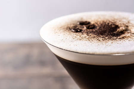 Martini espresso cocktail in glass on wooden table