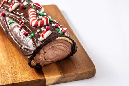 Chocolate yule log christmas cake isolated on white backgroundの写真素材