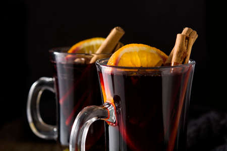 Traditional mulled wine with spices on wooden tableの写真素材