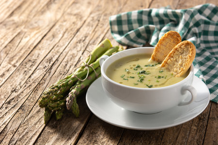Fresh green asparagus soup on wooden tableの写真素材