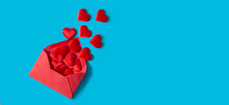 Hearts coming out of an red envelope on blue background
