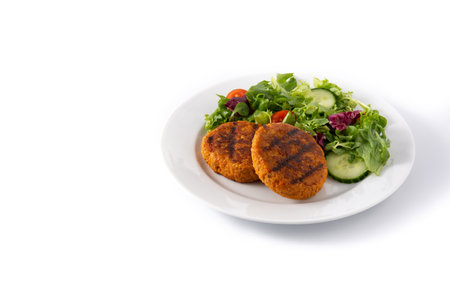 Delicious healthy chickpea burger and salad isolated on white background. Copy space