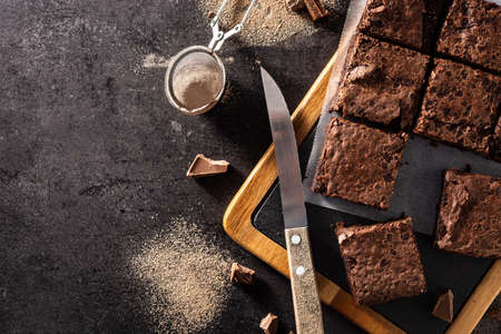Homemade pieces of brownies on black background. Top view. Copy spaceの写真素材