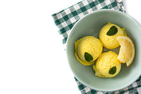 Lemon ice cream scoop decorated with mint leaves in bowl isolated on white backgroundの写真素材