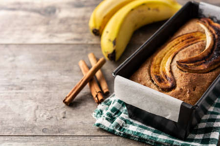Homemade banana bread on rustic wooden table.の写真素材
