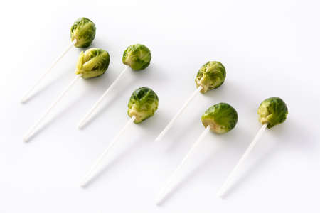 Set of brussel sprouts with lollipop sticks on white backgroundの写真素材