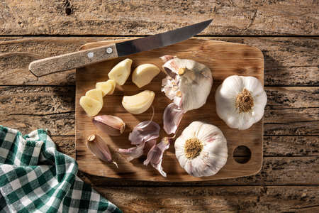 Garlic cloves on rustic wooden tableの写真素材