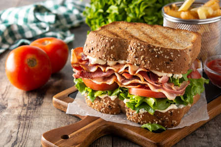 BLT sandwich with bacon, lettuce and tomato on wooden tableの写真素材