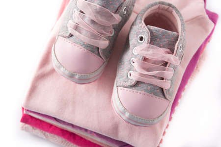 Baby rompers and baby shoes isolated on white backgroundの写真素材