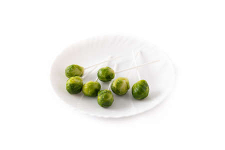 Set of brussel sprouts with lollipop sticks on white backgroundの写真素材