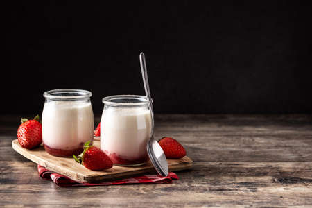 Panna cotta dessert with strawberry on wooden tableの写真素材