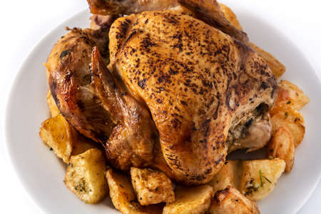 Homemade roasted chicken with potatoes isolated on white background