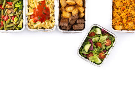 Take away healthy food in foil boxes isolated on white background. Top view. Copy spaceの写真素材