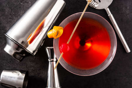 Traditional Manhattan cocktail with cherry on black backgroundの写真素材