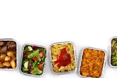 Take away healthy food in foil boxes isolated on white backgroundの写真素材