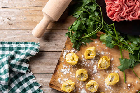 Uncooked pelmeni dumplings on rustic wooden table. typical russian foodの写真素材