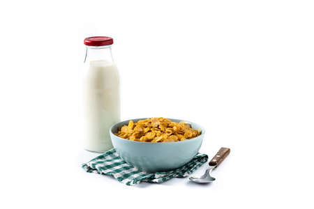 Corn flakes in a blue bowl and milk bottle isolated on white background