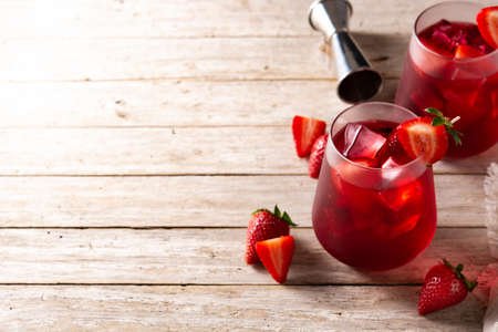 Strawberry cocktail in glass on rustic wooden tableの写真素材