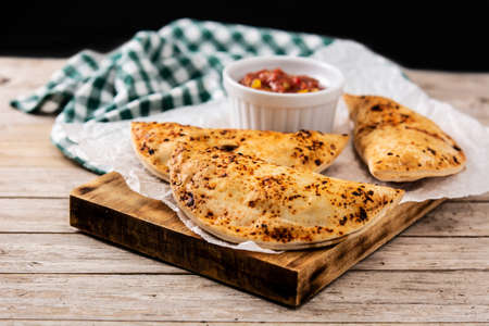 Traditional Chilean empanadas on wooden table