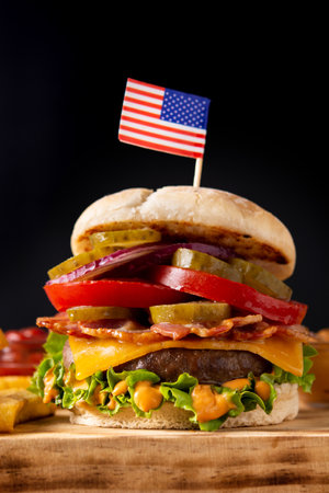 Beef burger with bacon on rustic wooden tableの写真素材