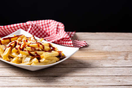 Traditional Canadian Poutine on wooden table. Copy spaceの写真素材