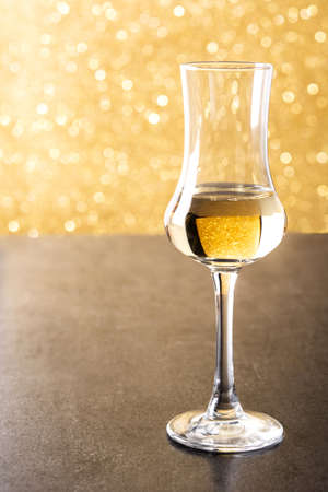 Italian golden grappa drink on bright background. Typical oktoberfest foodの写真素材