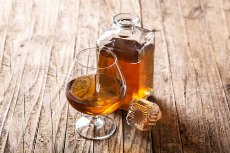 Cognac or whiskey drink on wooden table