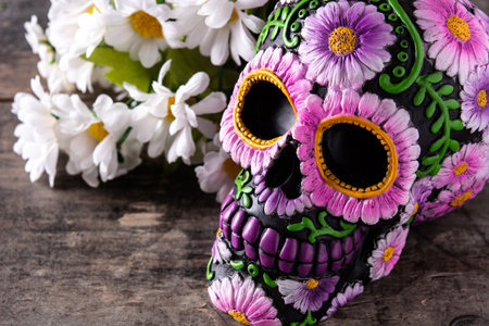 Typical Mexican skull and flowers diadem on wooden table. Day of the Dead.の写真素材