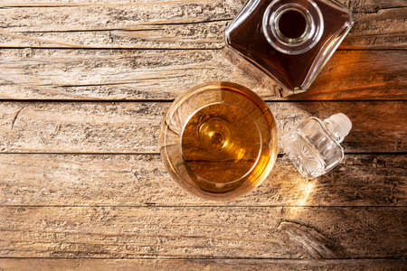 Cognac or whiskey drink on rustic wooden table and black background.の写真素材