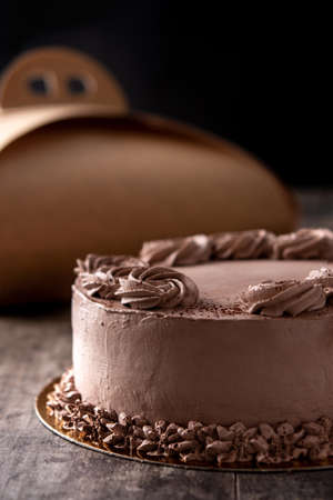 Piece of chocolate truffle cake on wooden table