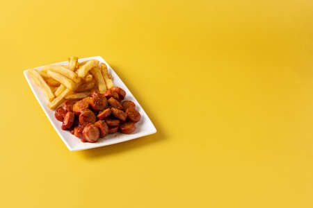 Traditional German currywurst on yellow backgroundの写真素材