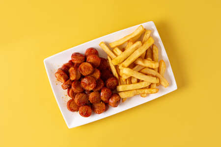 Traditional German currywurst on yellow backgroundの写真素材