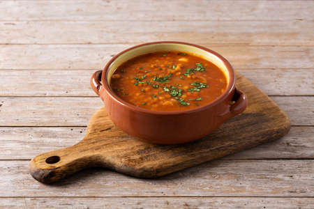 Red lentil soup in bowl on wooden tableの写真素材