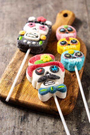 Candy skull lollipops on wooden table. Day of the deadの写真素材