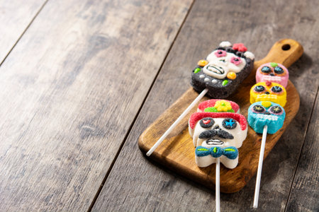 Candy skull lollipops on wooden table. Day of the deadの写真素材