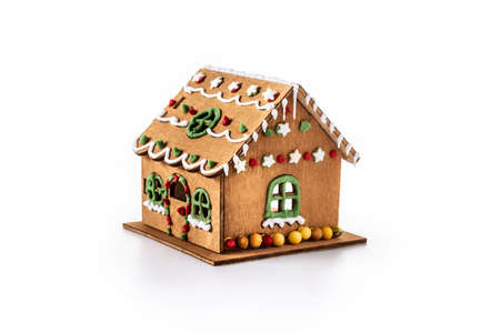 Christmas gingerbread house decorated with candies and glaze isolated on white background