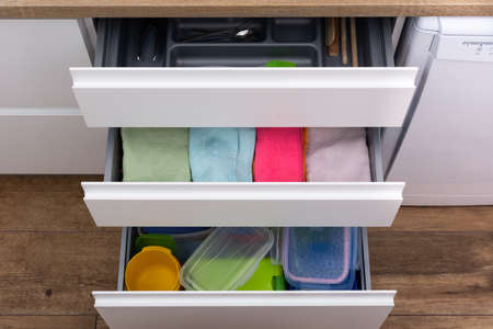 Drawer with cutlery, kitchen towels and lunch boxesの写真素材