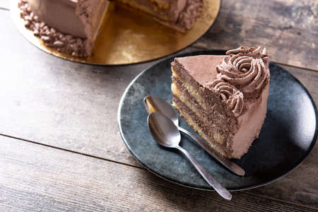 Piece of chocolate truffle cake on rustic wooden tableの写真素材