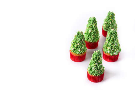 Christmas tree cupcakes isolated on white backgroundの写真素材