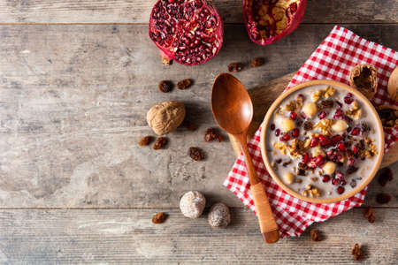 Traditional Turkish Noah's pudding in bowl on wooden tableの写真素材